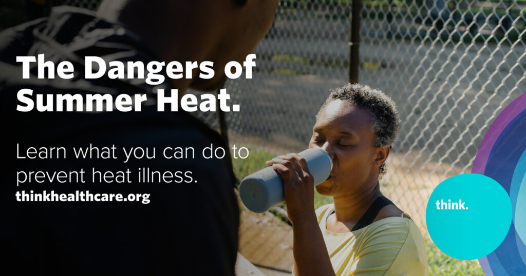 Mother drinking water at the park in the summer heat