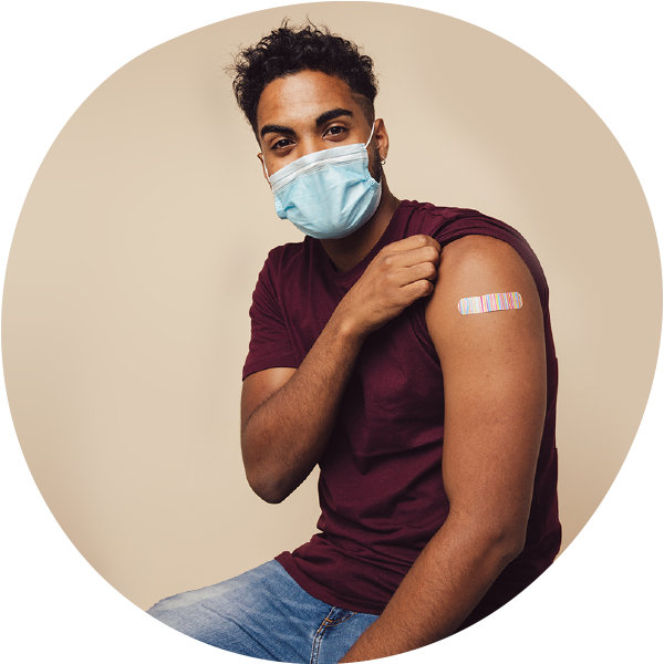 young african american man wearing a mask and bandage showing he received his covid-19 vaccination