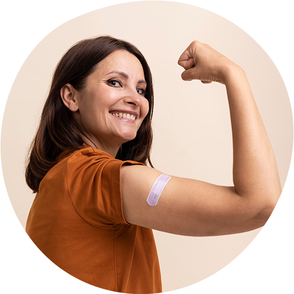 woman with strong arm showing she received her covid-19 booster shot