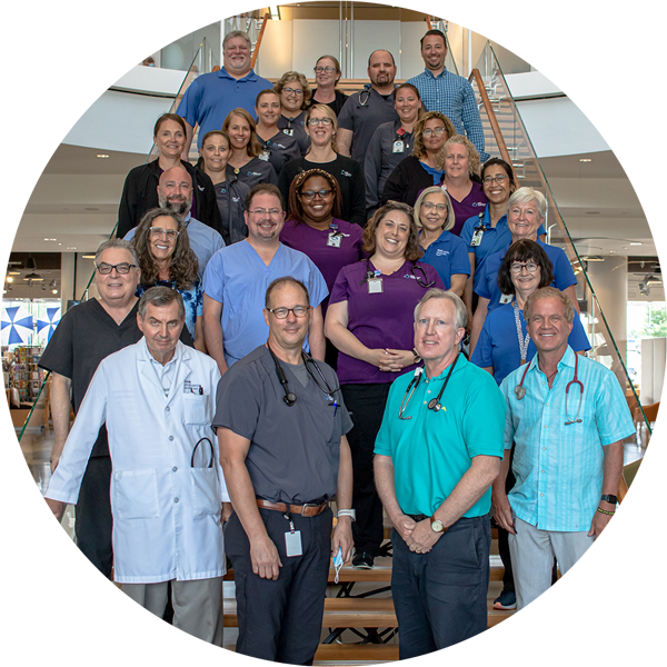 group of think physicians standing on first floor steps