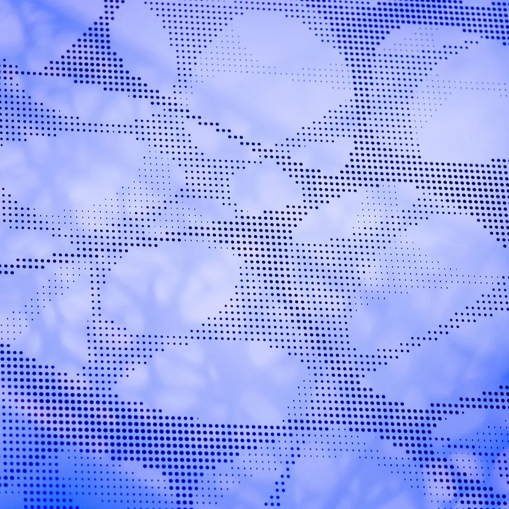 Abstract synaptic pattern of leaves in various shades of blue, with a dotted overlay creating a textured effect—think healthcare-inspired calm. The softly blurred background evokes tranquility and artistry.