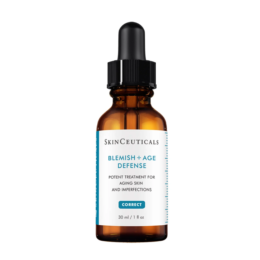 A brown glass dropper bottle labeled SkinCeuticals Blemish + Age Defense, a treatment for aging skin and imperfections, with a black dropper cap and blue-accented label, containing 30 ml (1 fl oz).