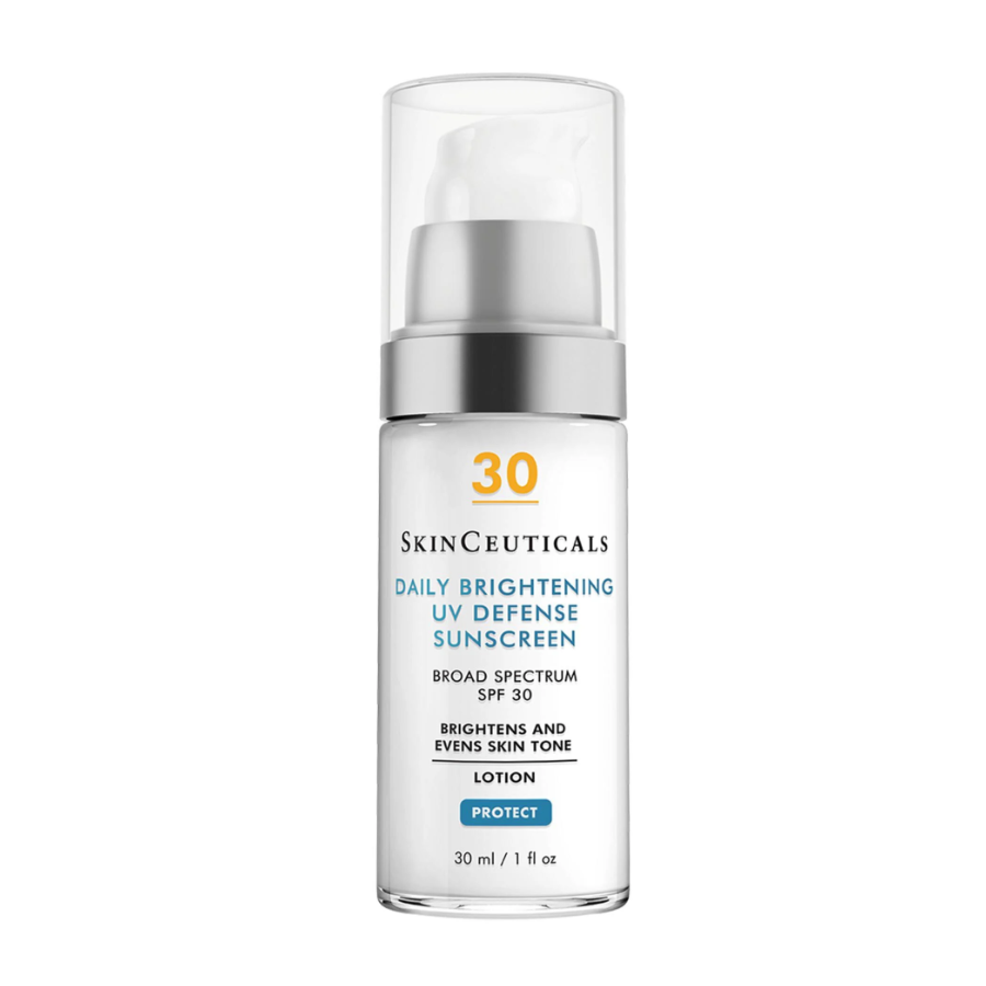 A clear pump bottle of SkinCeuticals Daily Brightening UV Defense Sunscreen SPF 30, labeled to brighten and even skin tone, with 30 ml (1 fl oz) of product. The packaging is white with black and blue text.